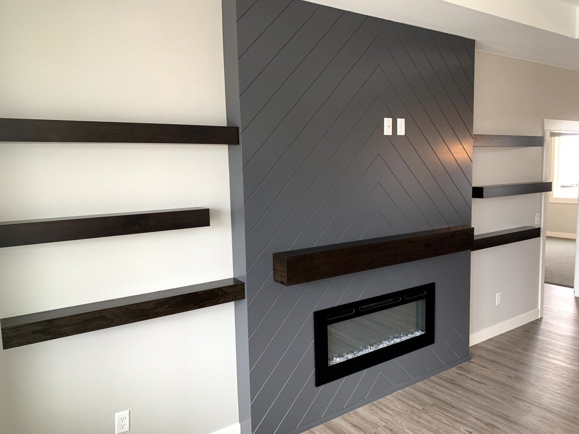 wood-faced fireplace and shelving side view