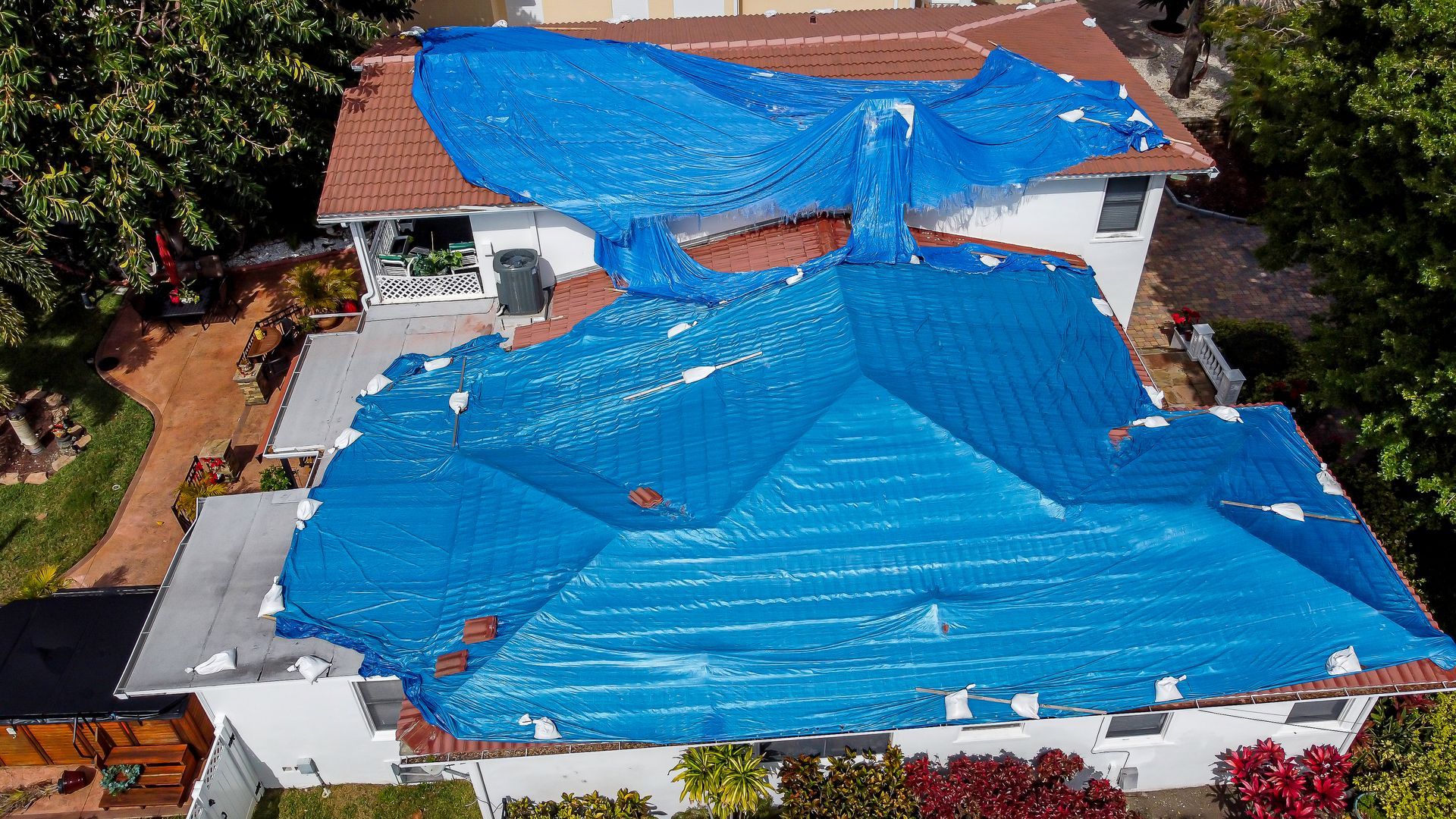 House with blue tarp