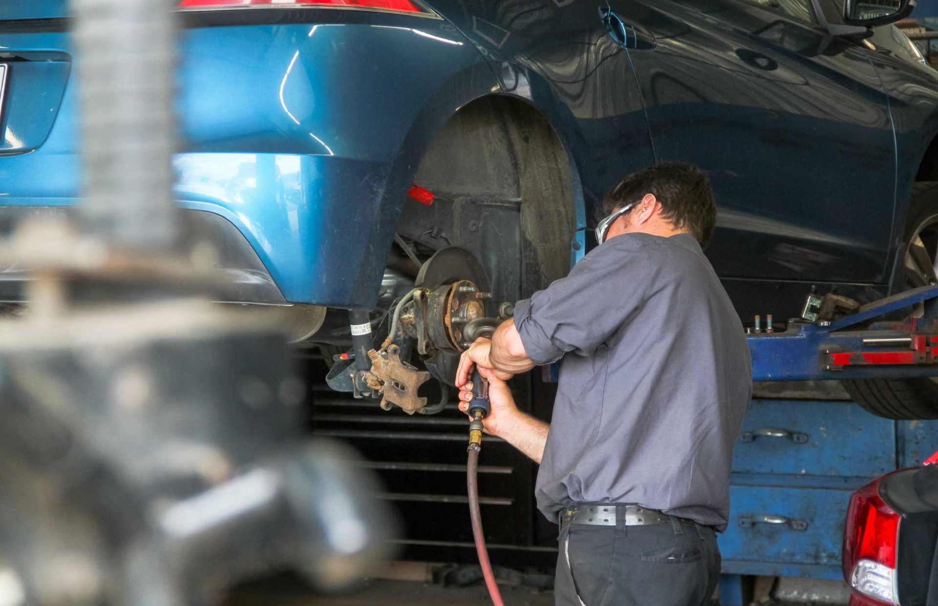 mechanic working on car wheel holder