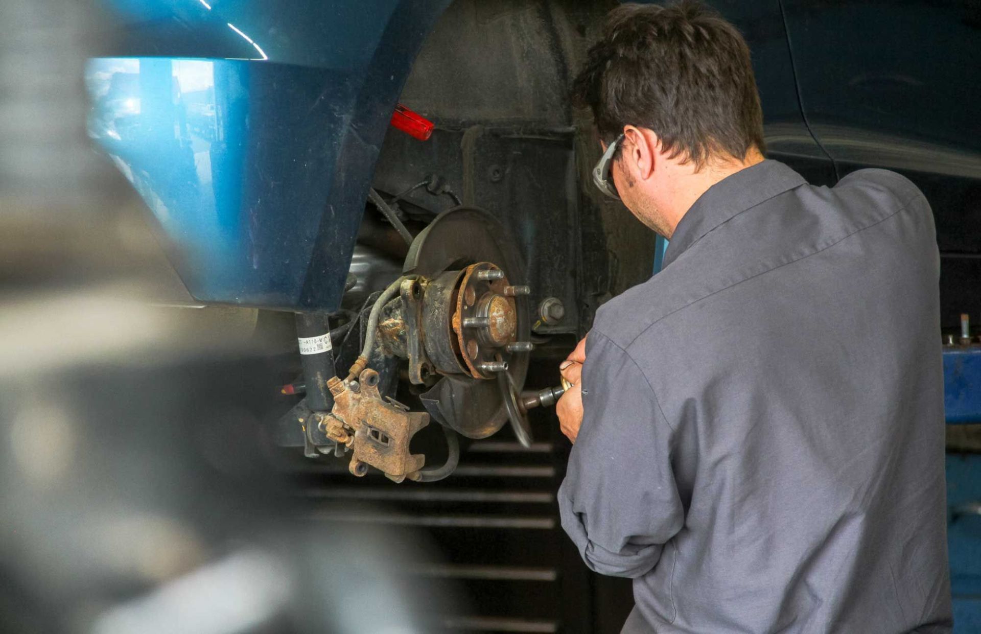 mechanic working on car tire holder