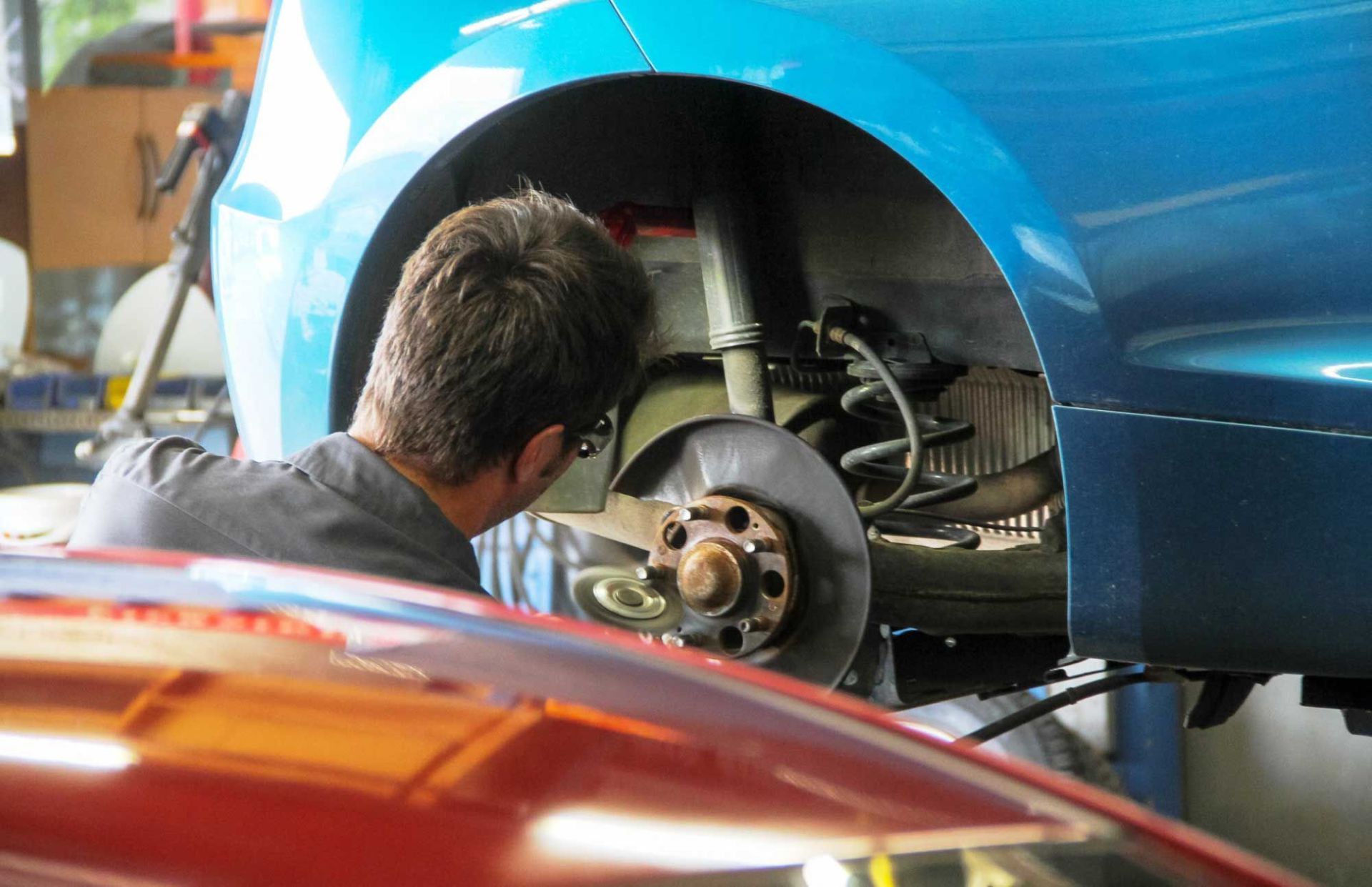 mechanic working on car tyre replacement servicing