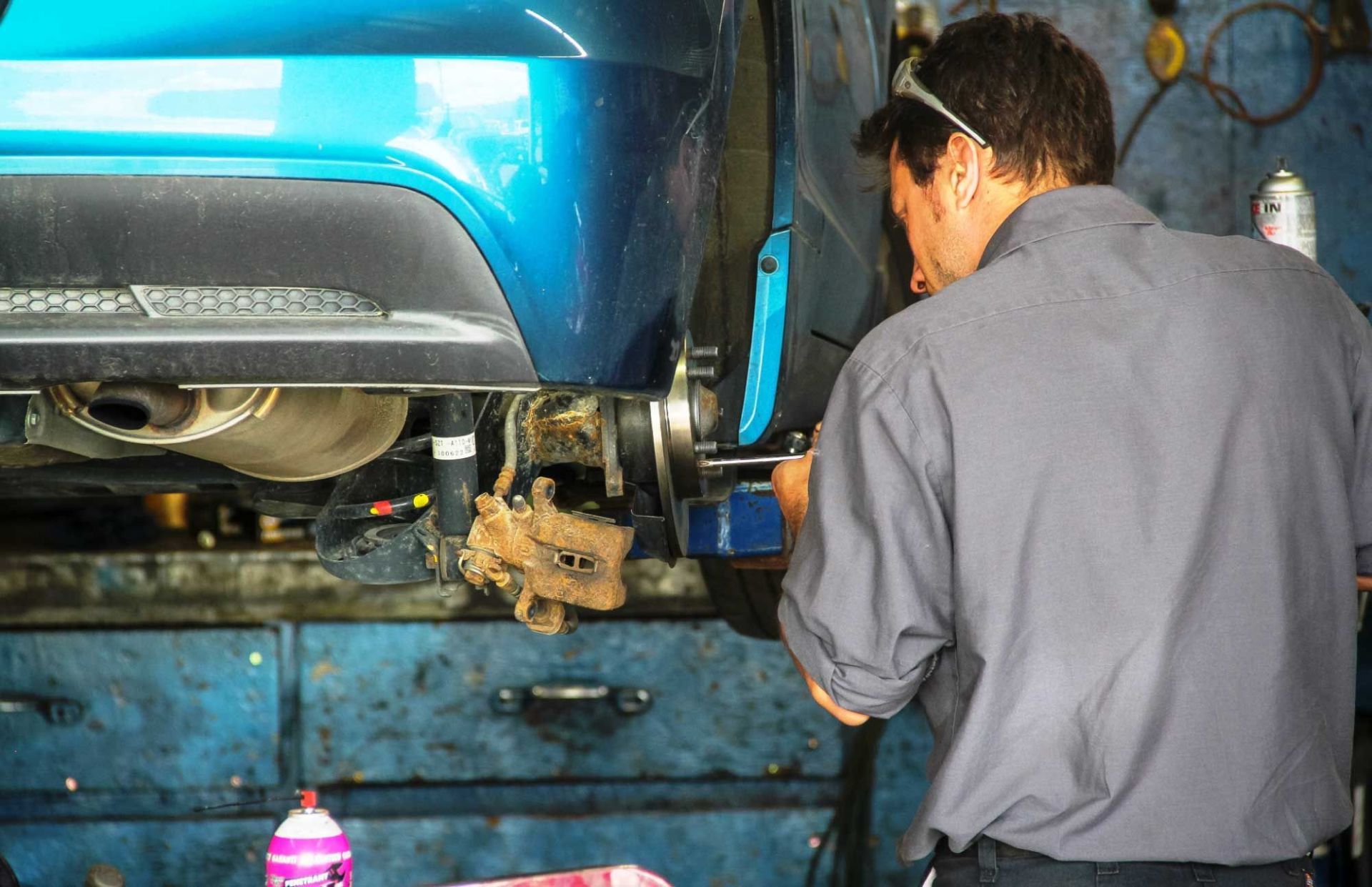 mechanic repairing car wheel holder