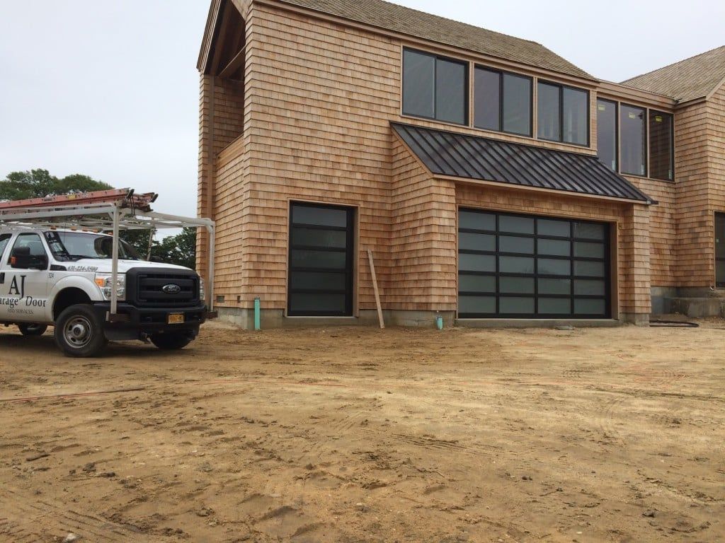 Brick house under construction with a white utility truck parked beside it