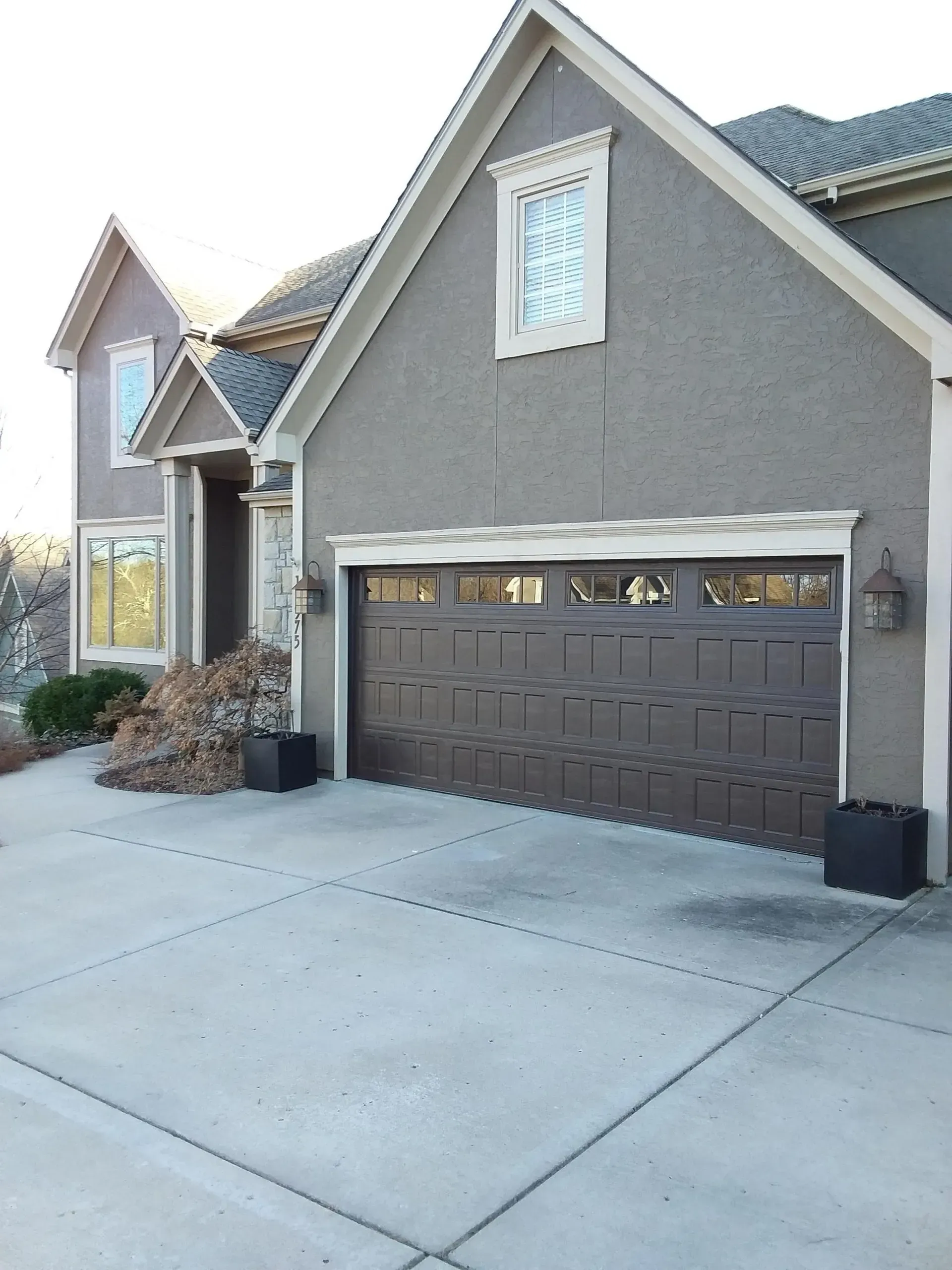 A large house with a brown garage door
