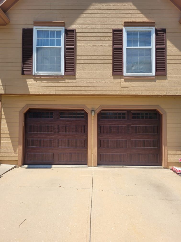A house with two garage doors and two windows