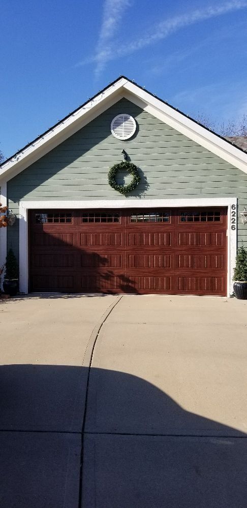 A garage door with a wreath on top of it.