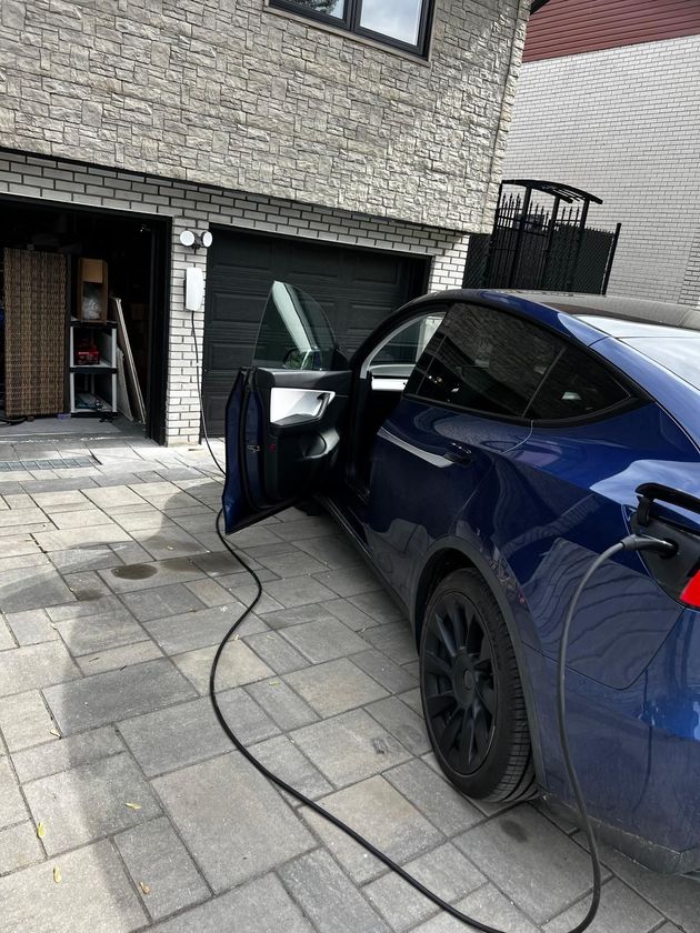 someone using an ev charger for his car