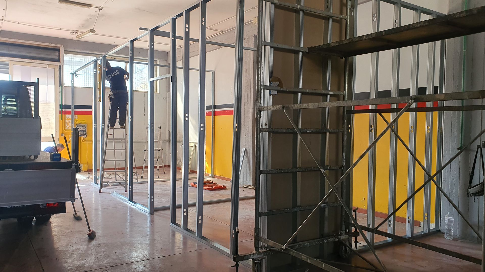 Un uomo è in piedi su una scala in un edificio in costruzione.