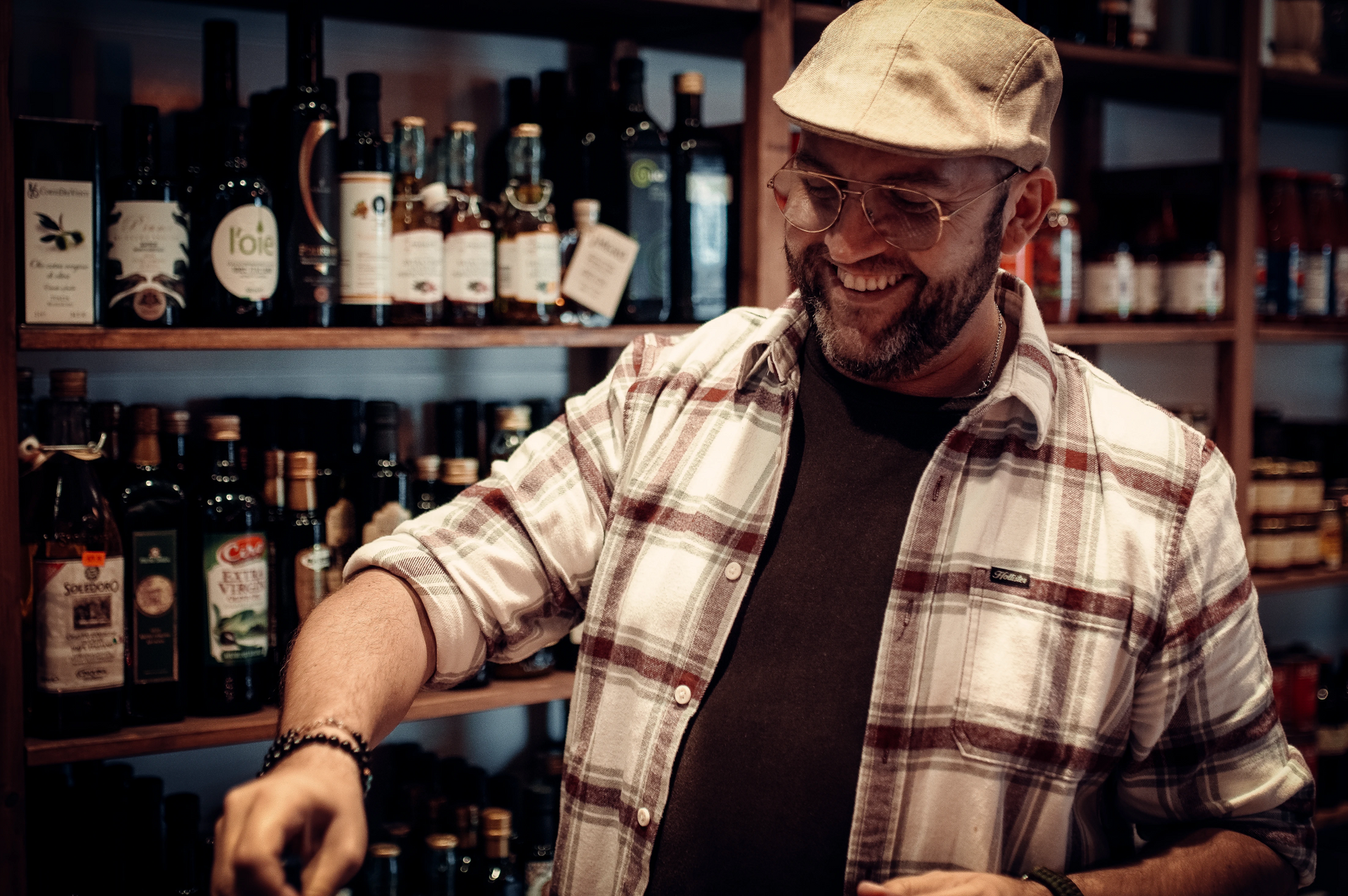 A man wearing a plaid shirt and a cap