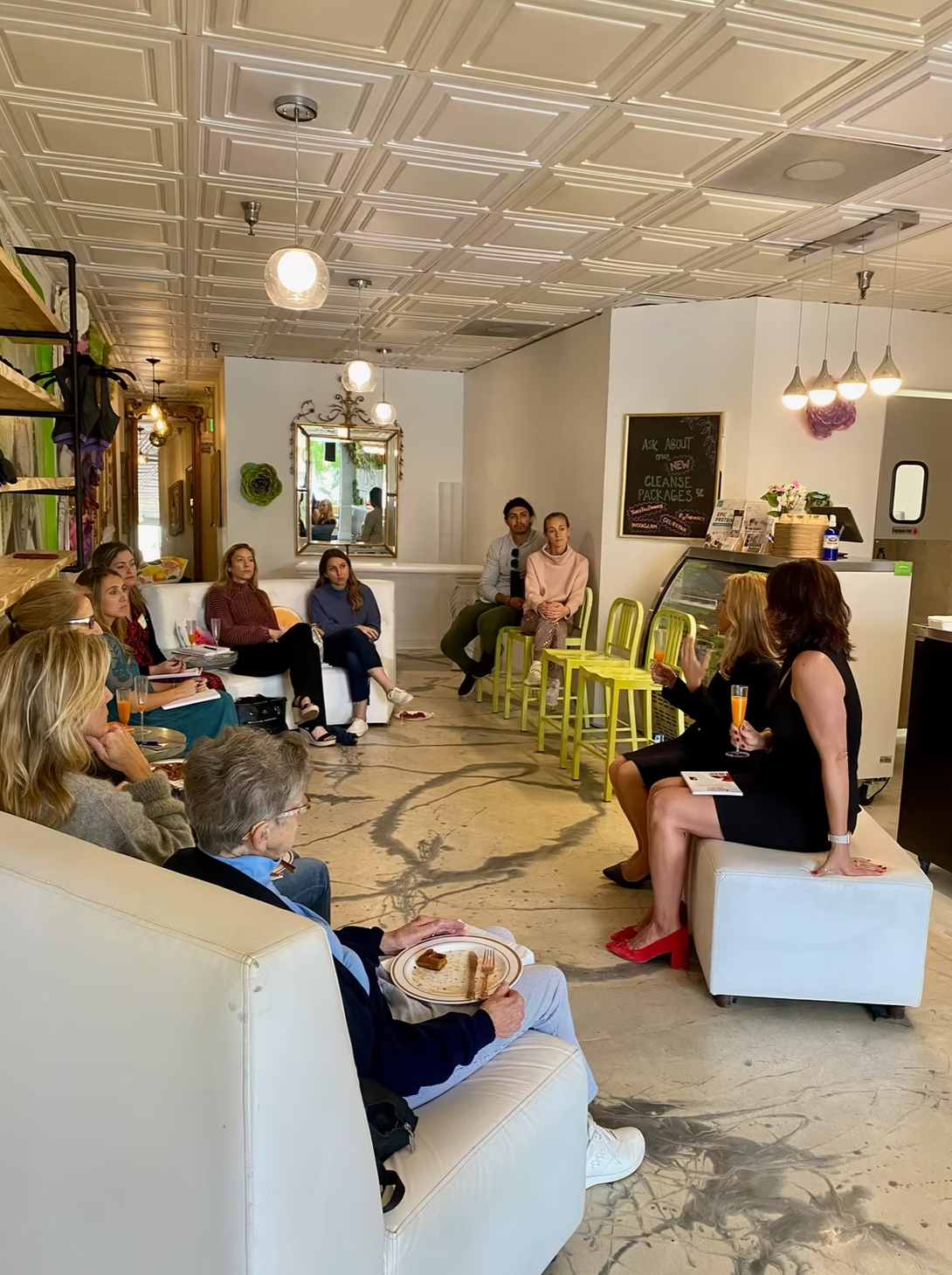 A group of people seated and gathered in a cafe setting