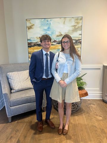 A bald man with a beard is wearing a suit and tie.