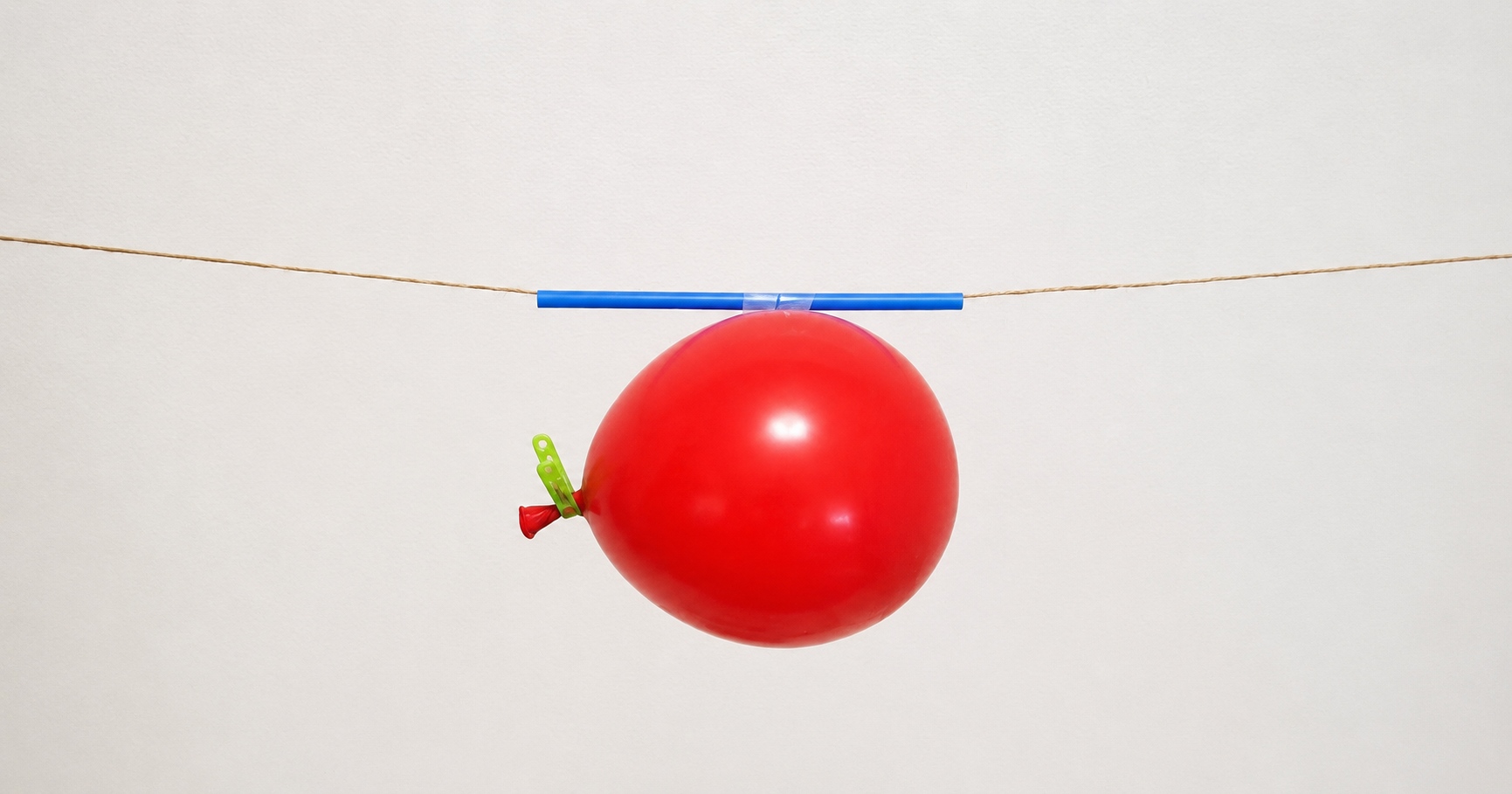 Balloon rocket science experiment demonstrating force and motion with a balloon attached to a straw