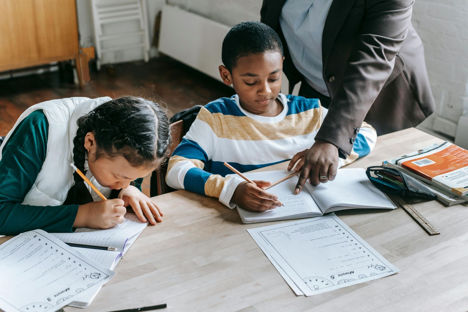 A teacher helping a student with their work