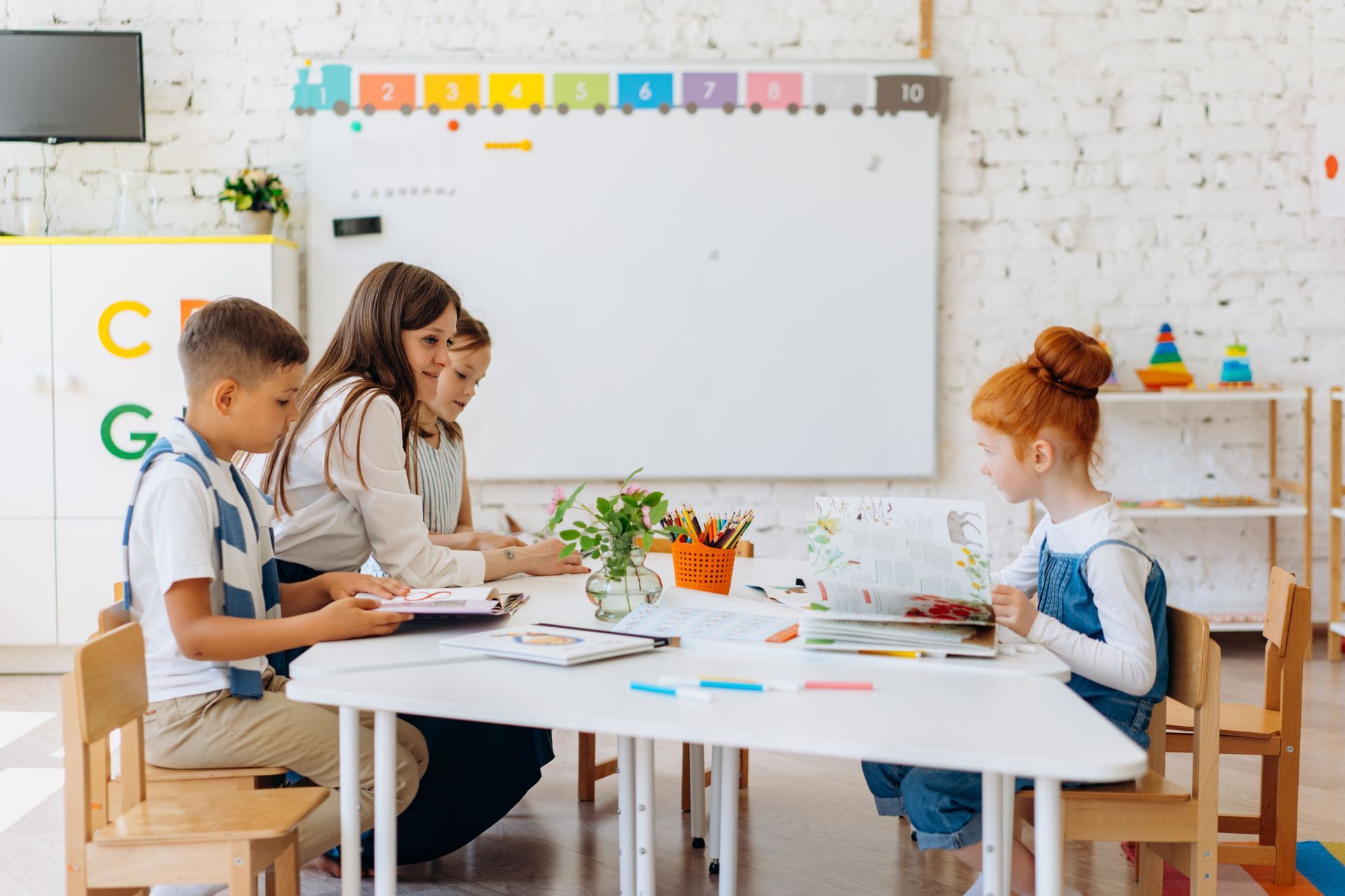Students and teachers working in a classroom.
