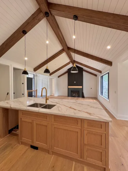 Great Room with shiplap ceiling, wood rafters and ridge beam detail, black board & batten fireplace