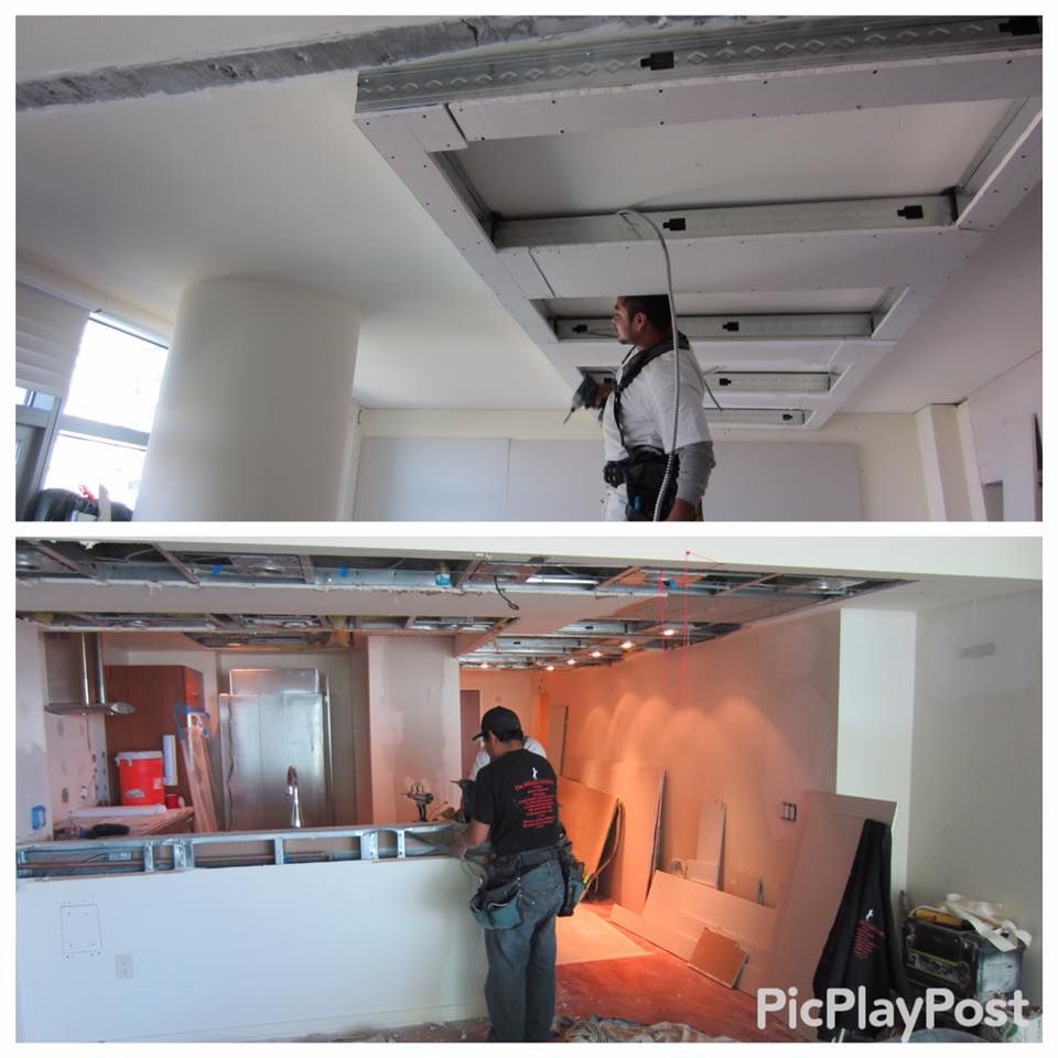 Two interior shots of a room during construction. Men working on drywall ceilings with recessed light boxes.