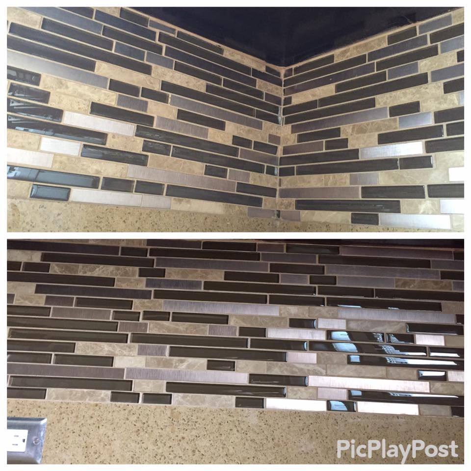 Close-up of a kitchen backsplash with rectangular tiles in shades of brown, silver, and tan.