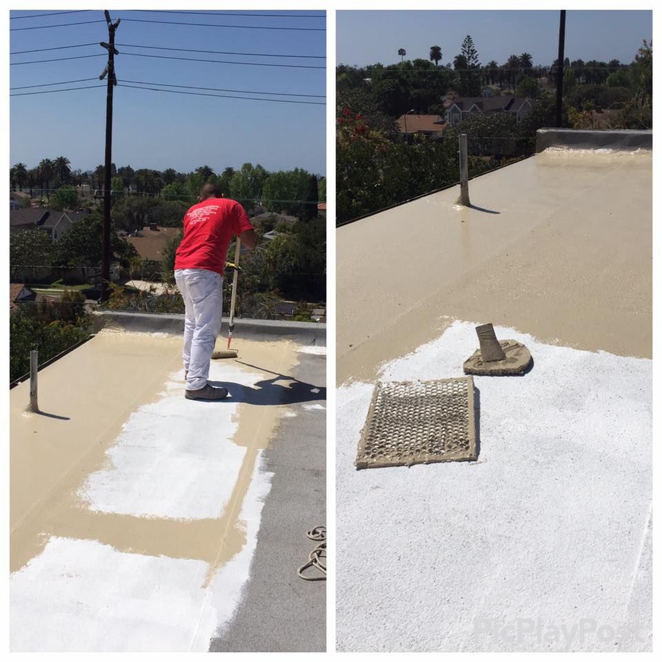 Person painting a flat roof white with a roller.