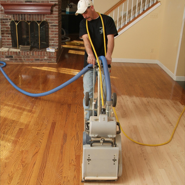 A Man performing hardwood floor refinishing in Thornton, Colorado 