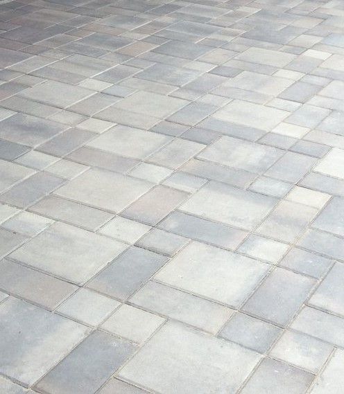 Grey and blue pavers arranged in a repeating pattern on a walkway.