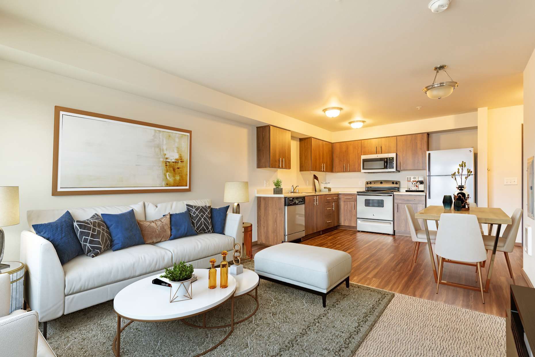 Living room with white sofa, open kitchen, and dining area.
