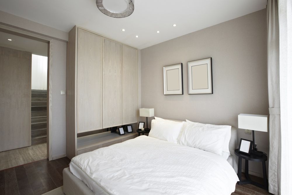 A Bedroom With A Large Bed And Two Pictures On The Wall — Morphett Construction In Tamworth, NSW