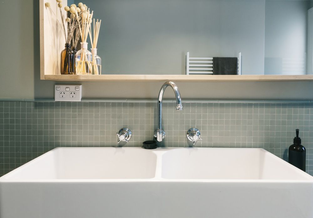 A Bathroom Sink With A Faucet And A Mirror Above It — Morphett Construction In Quirindi, NSW