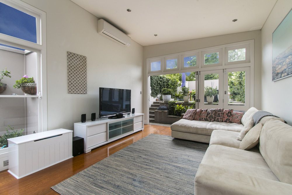 A Living Room With A Couch And A Flat Screen TV — Morphett Construction In Quirindi, NSW