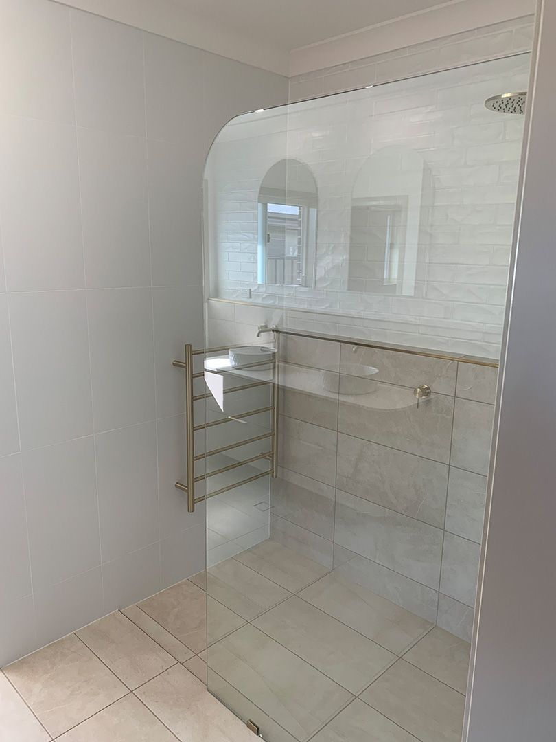 A Bathroom With A Walk In Shower And A Mirror — Morphett Construction In Tamworth, NSW