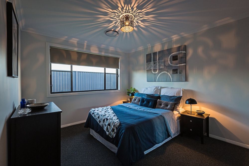 A Living Room With A Large Sectional Couch And Hardwood Floors — Morphett Construction In Tamworth, NSW