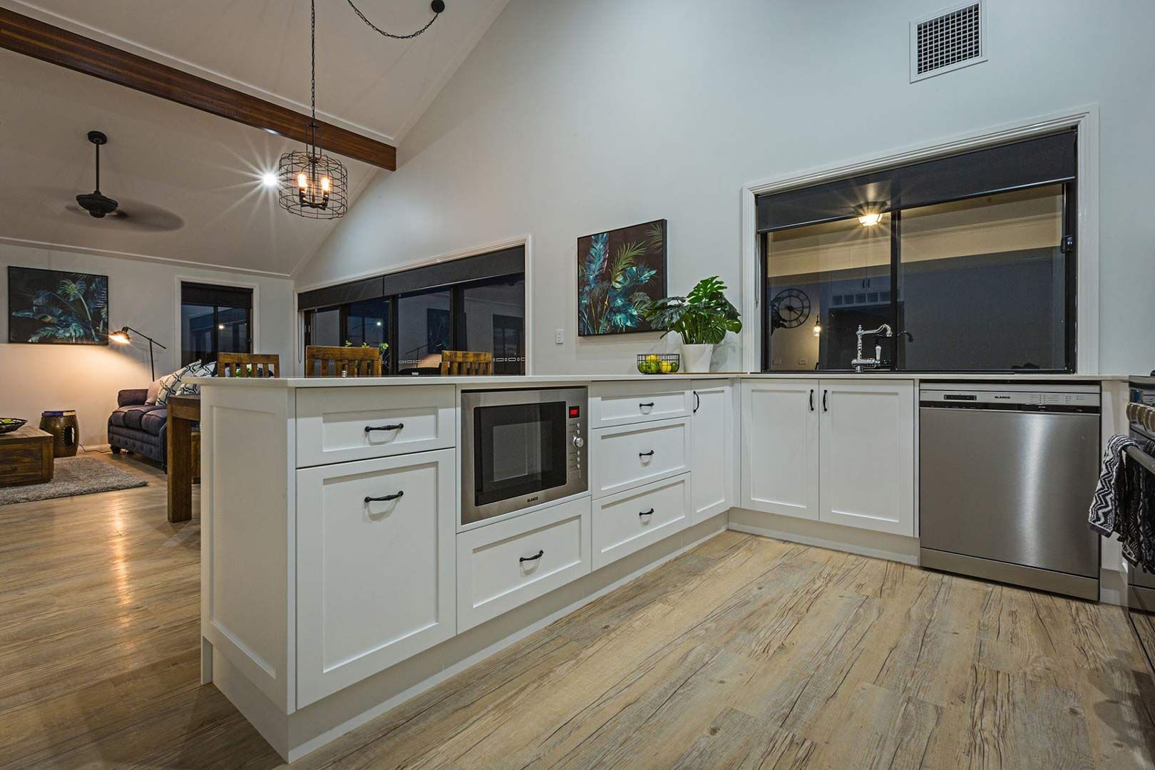 A Kitchen With White Cabinets And Stainless Steel Appliances — Morphett Construction In Calala, NSW