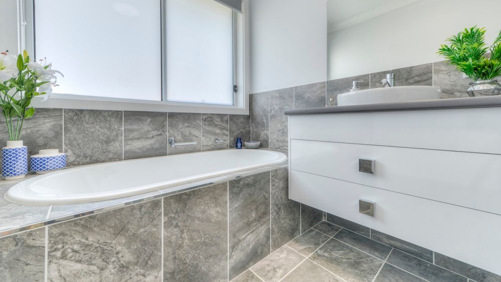 A House With A Red Roof And White Garage Doors — Morphett Construction In Gunnedah, NSW