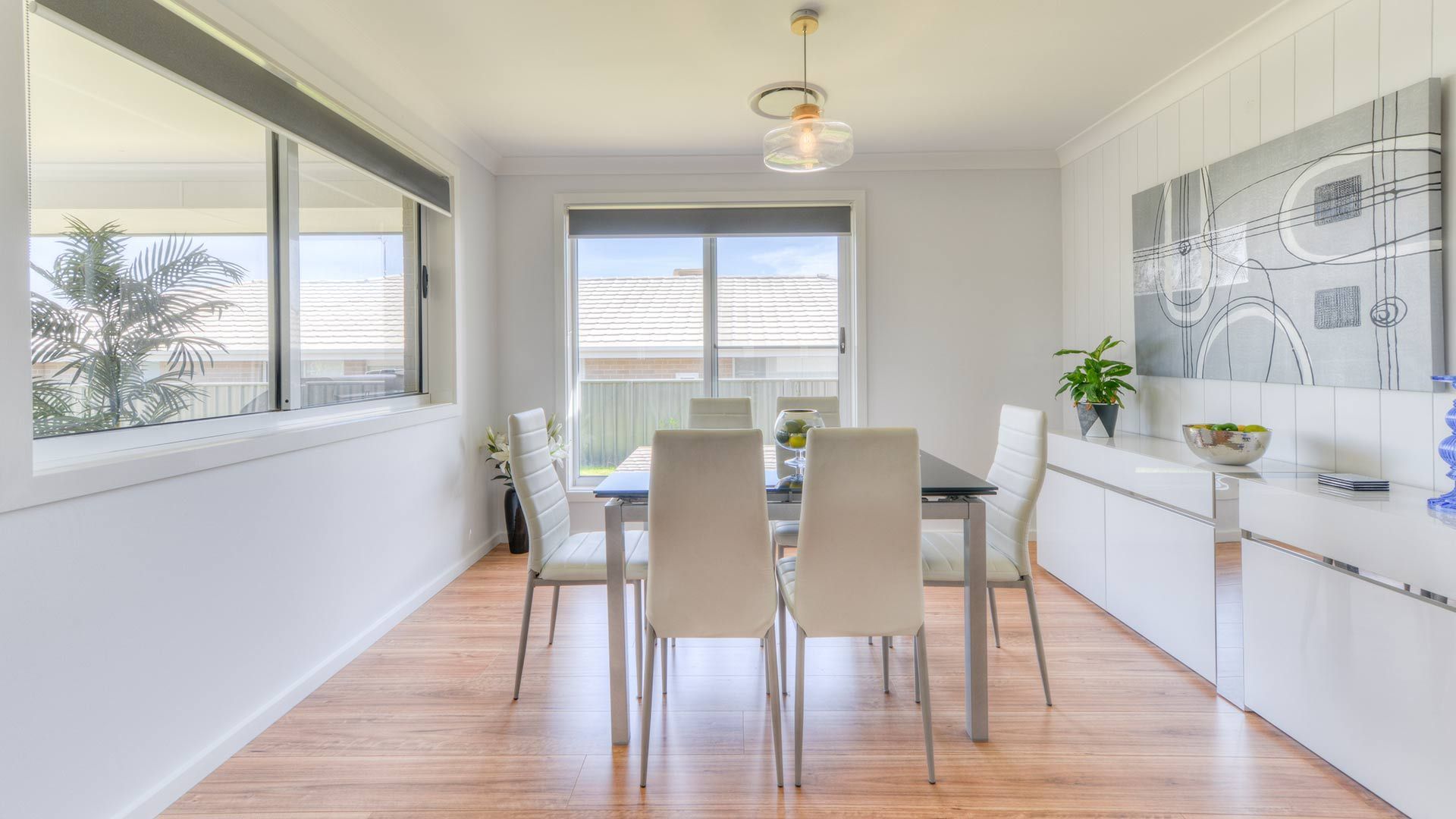 A Dining Room With A Table And Chairs And A Large Window — Morphett Construction In Calala, NSW