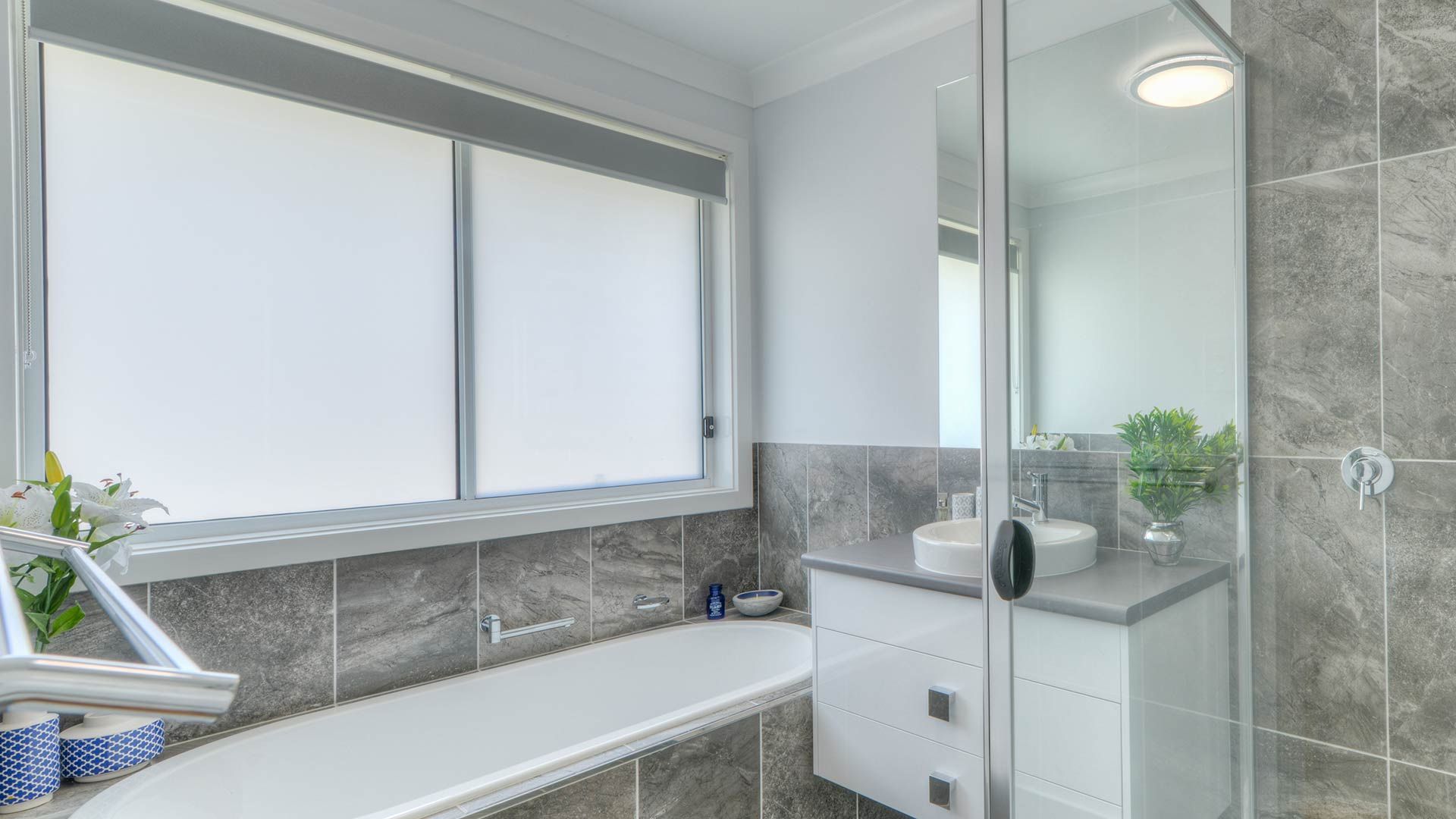 A Bathroom With A Tub , Sink , Mirror And Shower — Morphett Construction In Calala, NSW