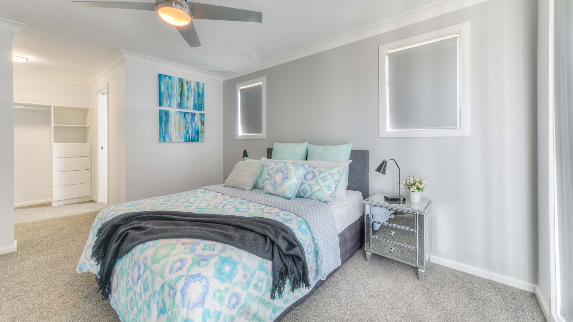 A Bedroom With A Bed , Nightstand , And Ceiling Fan — Morphett Construction In Calala, NSW