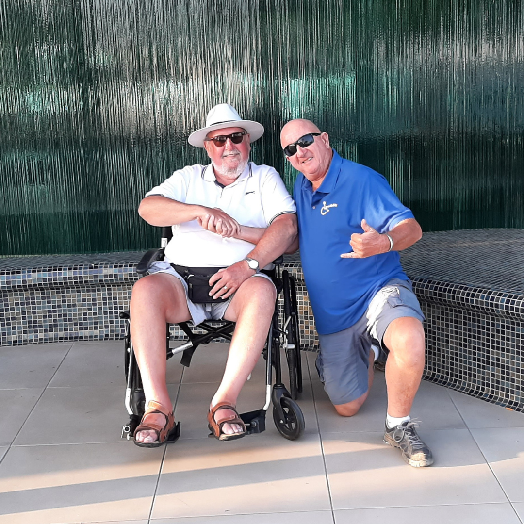 Crazy DAVID, founder of LanzAbility, shaking hands with a holiday guest in a wheelchair