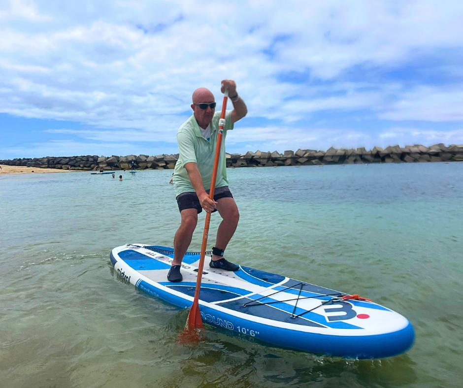 Crazy DAVID is riding a paddle board in the water.