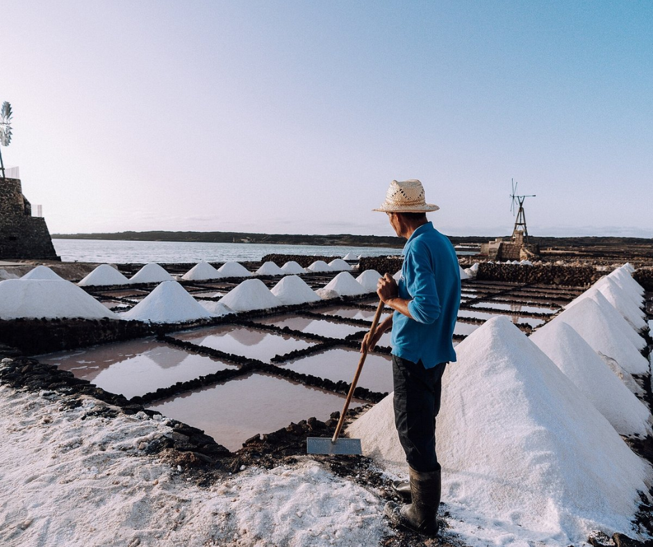Person working at the saltworks at Las Salinas de Janubio