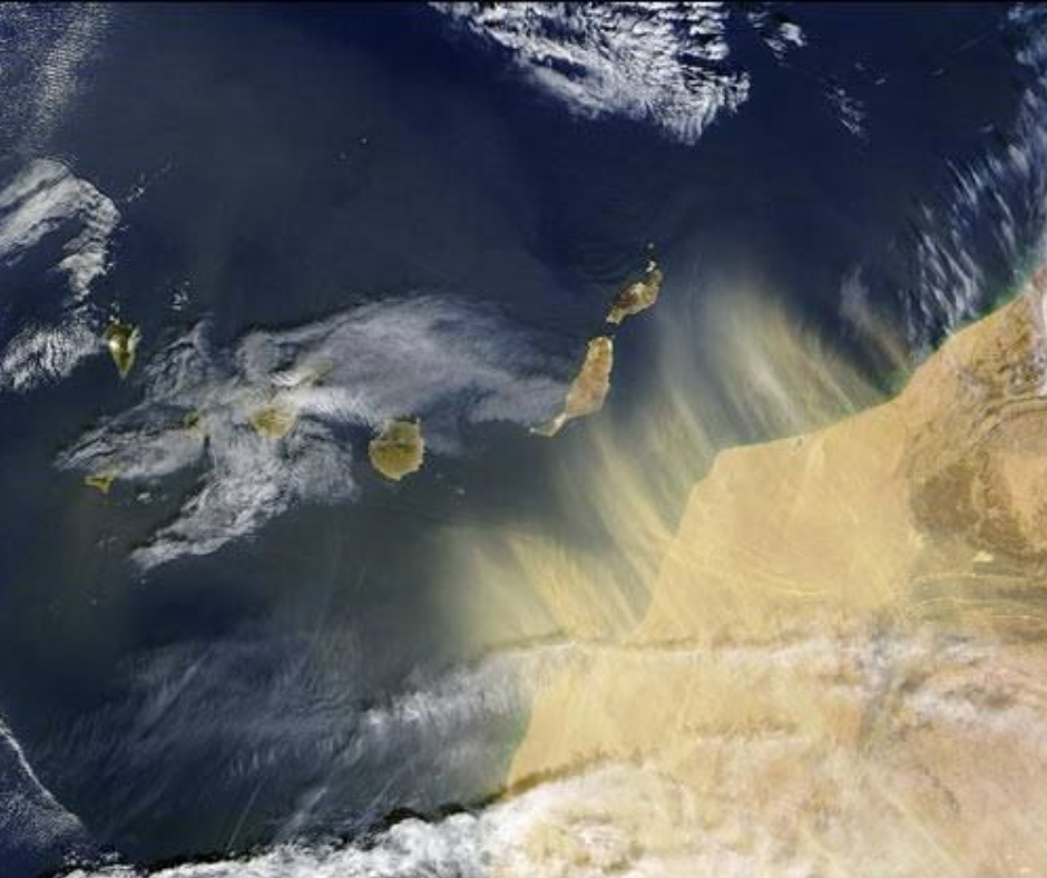 An aerial view of the earth with clouds and sand