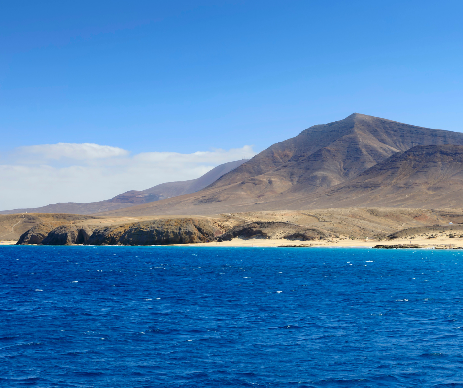 A large body of water with mountains in the background.