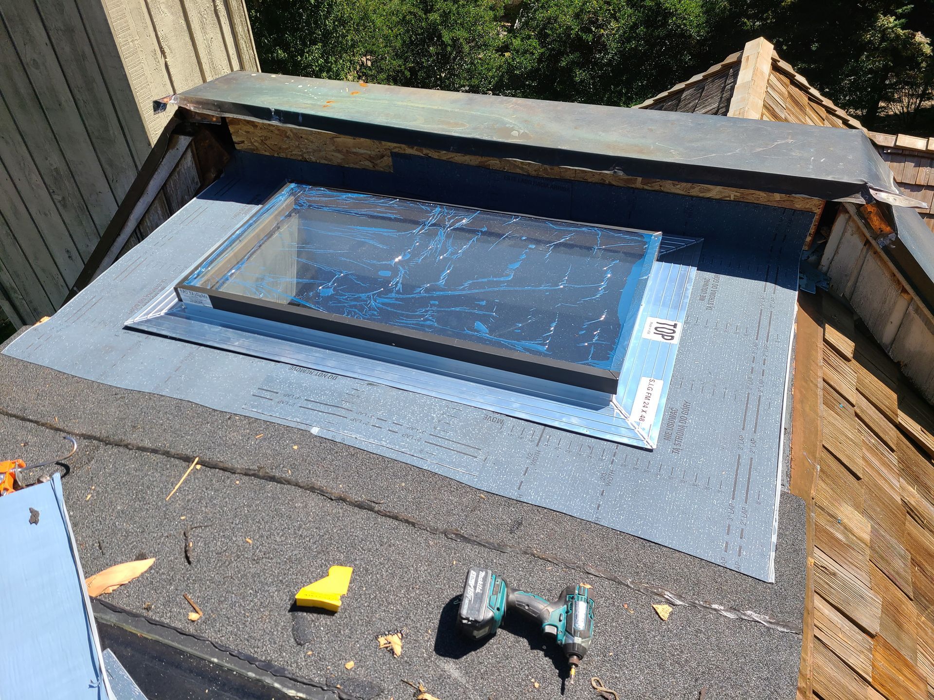 The roof of a house with a blue sky in the background