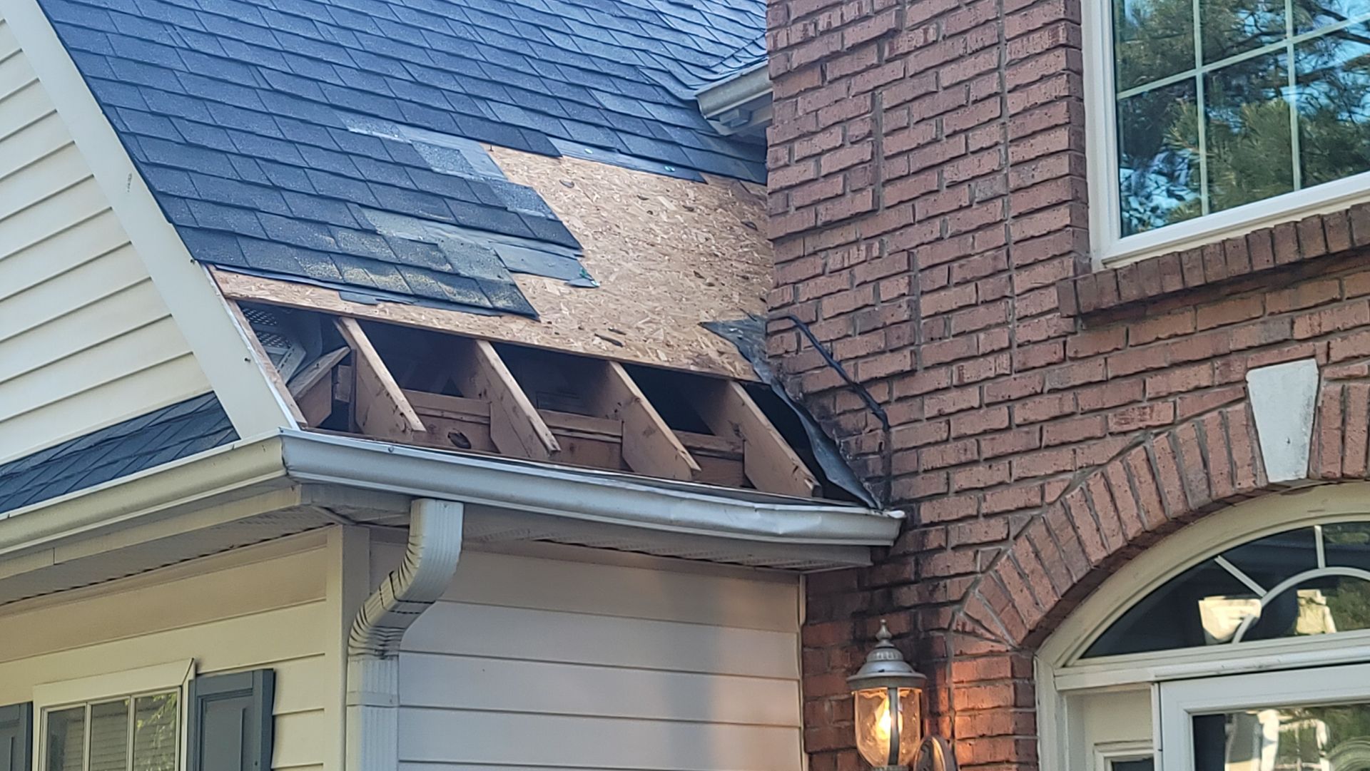 A close up of a black roof with a screw in it.