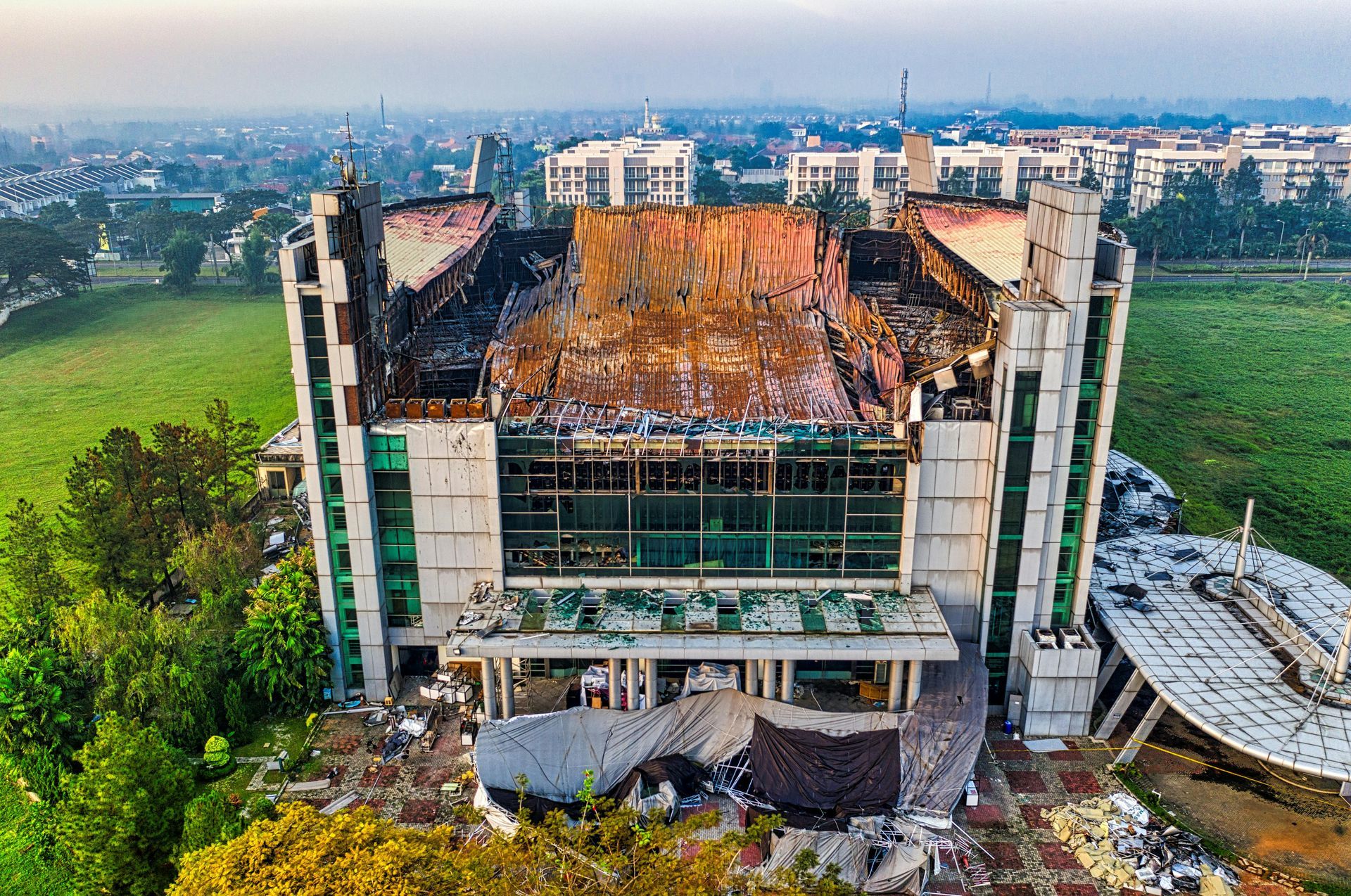An aerial view of a large building under construction in a city.