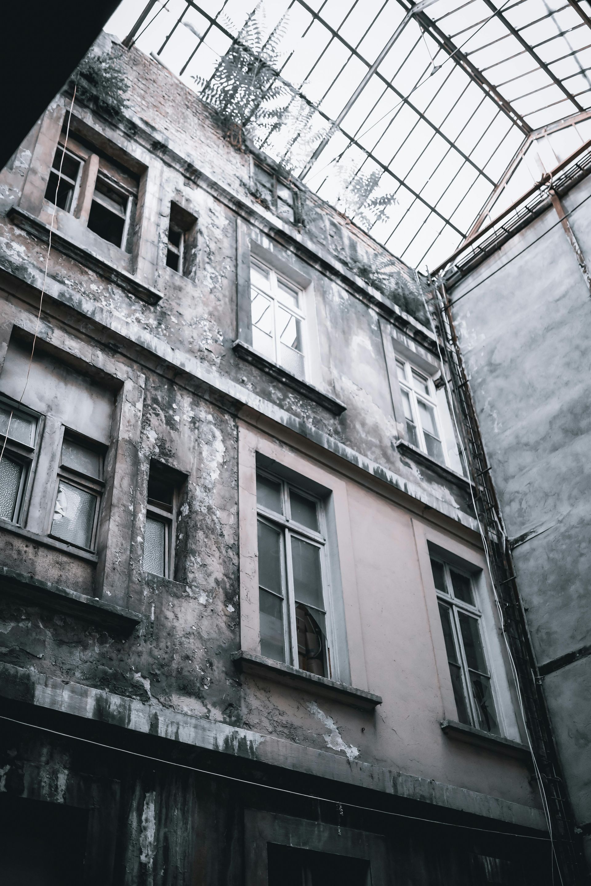Looking up at an old building with a glass roof.