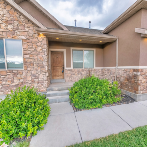 A house with a stone facade and a wooden door
