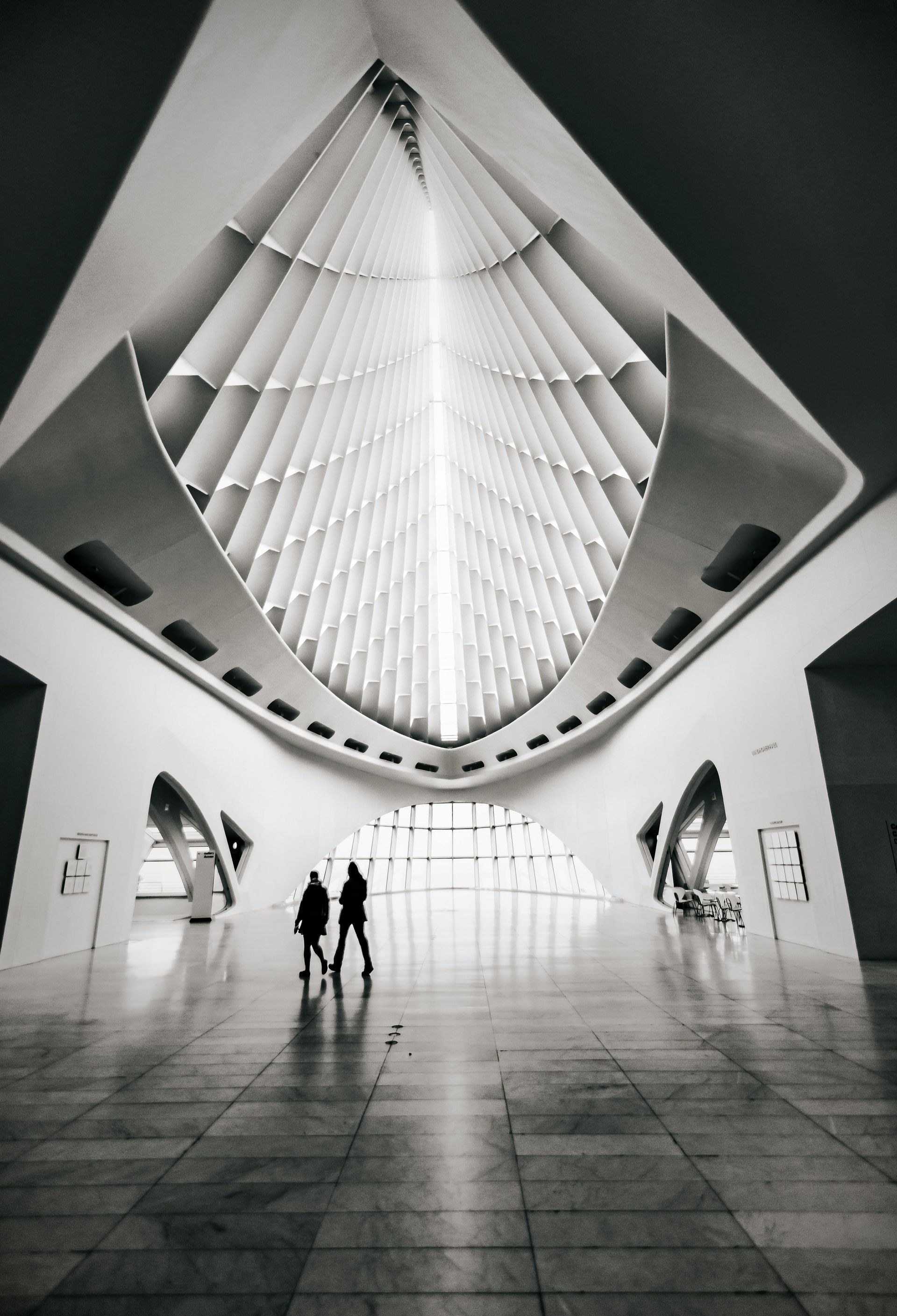 Spanish-style home with a white stucco facade, arched entry, and courtyard.