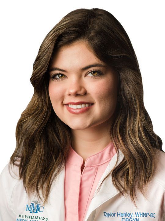 A woman in a white lab coat is smiling for the camera.