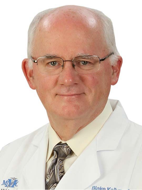A bald man wearing glasses and a white lab coat