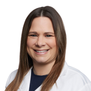 A woman wearing a white lab coat with the name jessica on it