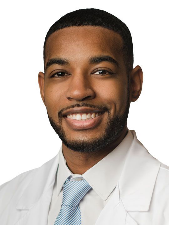 A woman wearing a white coat with Kelly Barnett, FNP-C written on it